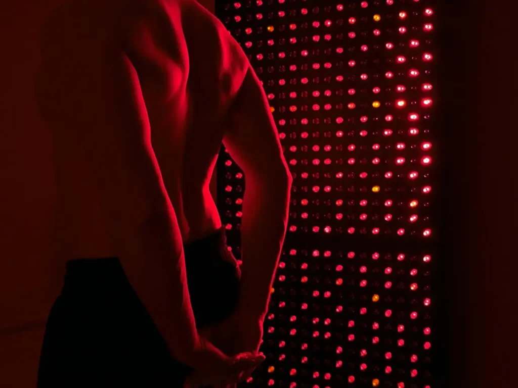 View of a person's back doing red light therapy with the lumavit studio device