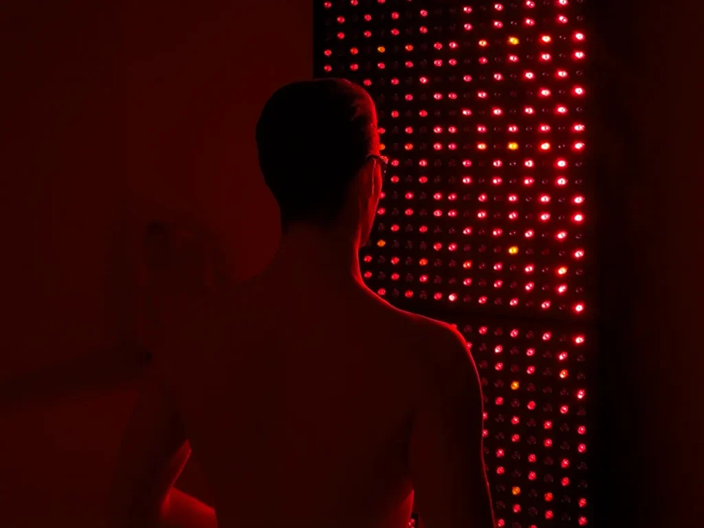 View of a person facing the lumavit studio device doing red light therapy